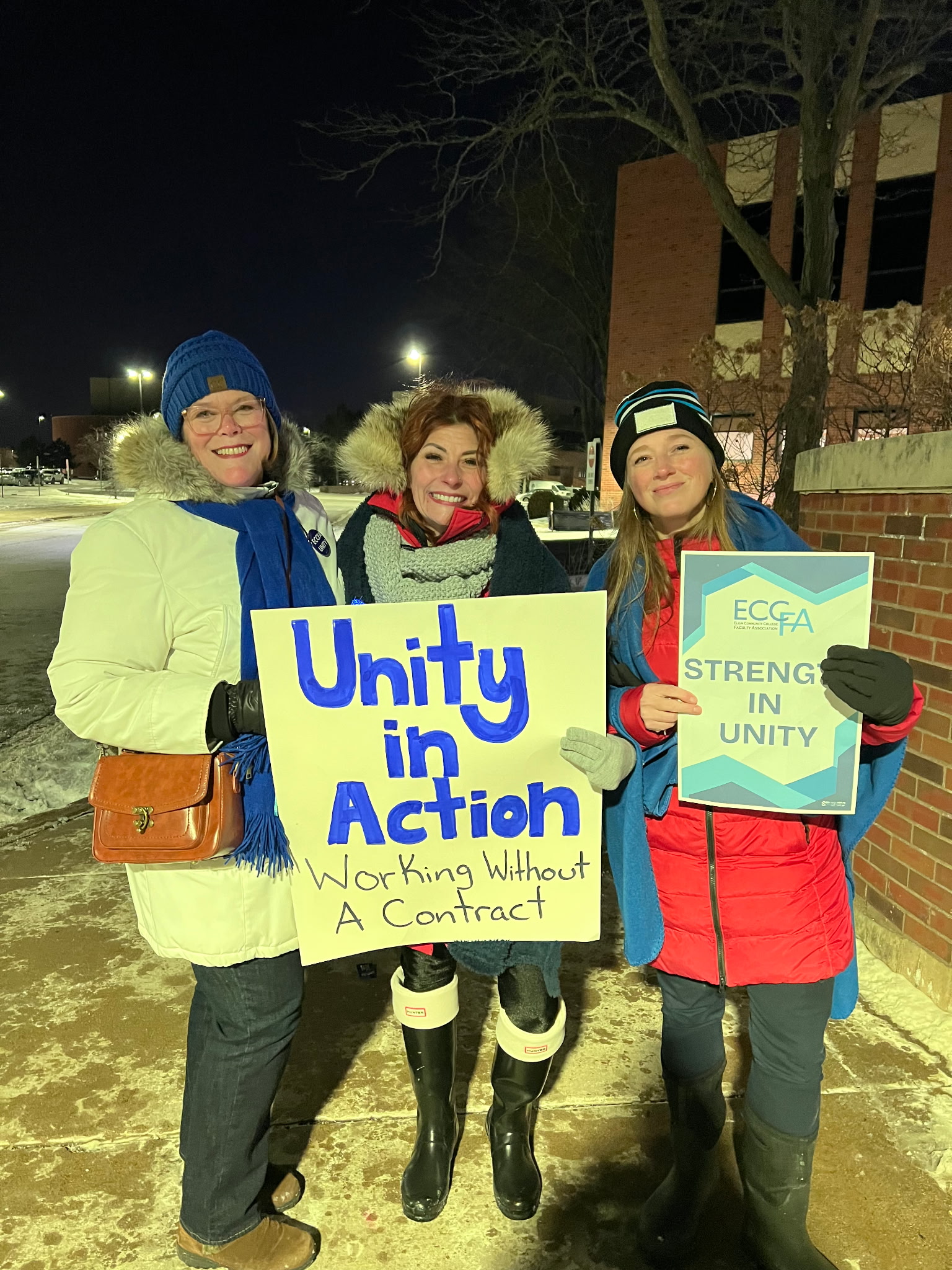 ECCFA faculty members Kim Tarver, Michelle Kershner, and Kari Farooqie show off their signs while picketing January 2026